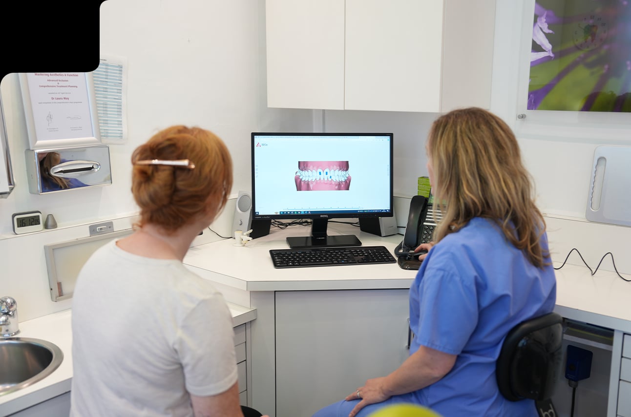 Dental team reviewing patient treatment information at Wycombe Dental Centre